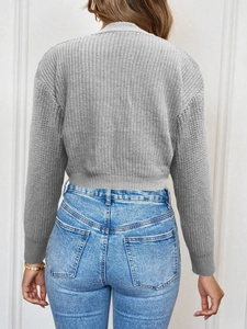Back view of a thick grey knit cardigan with vertical stripes and long sleeves