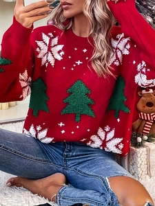 Close-up of red Christmas sweater featuring textured green tree and white snowflake patterns