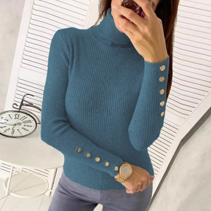 Detail of blue high-neck ribbed knit sweater featuring golden button cuffs