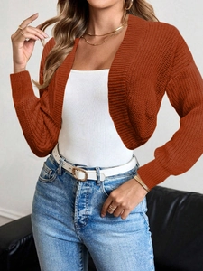 Detail of rust red chunky knit cardigan texture with ribbed cuffs and drop shoulder