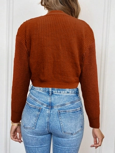 Detail shot of caramel ribbed knit cardigan texture and slim fit design from the back view