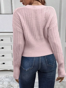 Rear view of light pink knit sweater with chunky vertical texture and ribbed hem detail