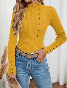 Detailed view of yellow ribbed knit sweater with decorative buttons on collar and cuffs