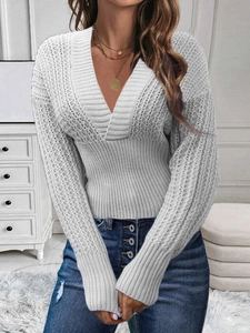 Detail of grey V-neck knit sweater with ribbed texture and layered gold necklace