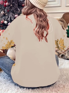 Detailed back view of a beige Christmas sweater with golden leaf patterns on the sleeves