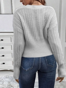 Rear view of a white chunky knit sweater for women with ribbed cuffs and hemline detail