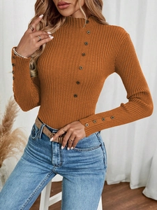 Detail view of ribbed knit sweater showing vintage metal buttons on neckline and sleeve cuff