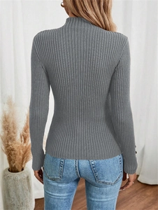 Macro shot of grey ribbed knit texture and button details on a slim-fit winter sweater