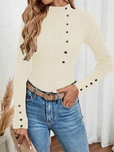 Close-up of ribbed knit texture and decorative vintage buttons on a beige sweater