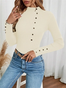 Detailed texture of ribbed knit sweater with decorative buttons on collar and cuffs