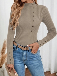Close-up of ribbed knit sweater with decorative buttons on collar and cuffs in earth tone
