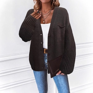 Close-up of dark grey button-down knit cardigan with pocket and textured vertical ribs