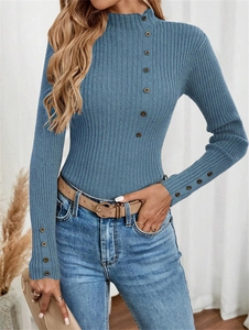 Detailed view of blue ribbed knit sweater featuring decorative buttons on the neck and cuffs