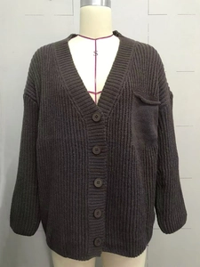 Detail of V-neck buttoned knit cardigan sweater with front pocket in dark grey