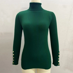 Detail of dark green knit sweater featuring ribbed texture and gold buttons on cuffs