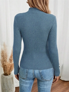 Back view of a blue ribbed knit sweater with a turtleneck collar on a model