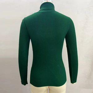Close-up of dark green turtleneck sweater showing vertical ribbed knit texture on back