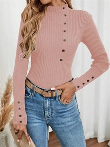 Detailed close-up of ribbed texture and elegant shoulder buttons on pink sweater