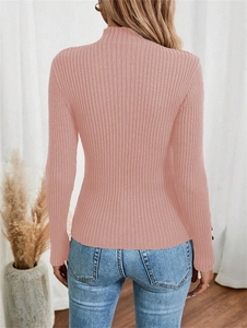Rear view of a woman wearing a pink ribbed knit sweater with a slim fit and a high neck