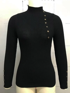 Close-up of ribbed knit sweater featuring diagonal metal button details on the collar