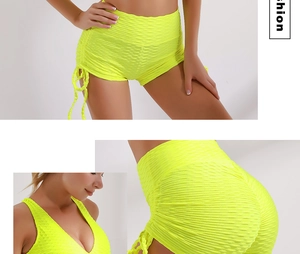 Detail of high waist honeycomb yoga shorts with side drawstrings in neon yellow set