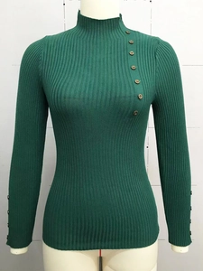 Detail of dark green ribbed knit sweater featuring decorative buttons on the collar and cuffs