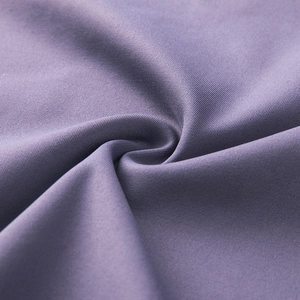 Macro detail of purple seamless high-elastic fabric showing smooth twill weave texture