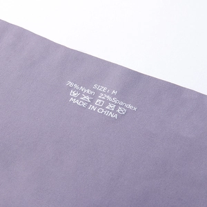 Detail shot of purple seamless underwear with fabric labels showing 78% nylon material
