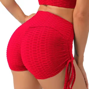 Detail of red honeycomb yoga shorts featuring high waist and adjustable side drawstrings