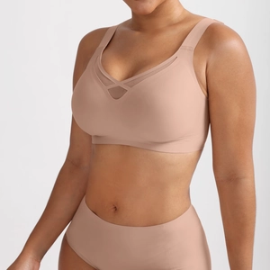 Detail of a nude seamless bra with criss-cross mesh ventilation and wide straps