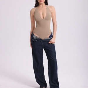Detail of high-neck deep V bodysuit in khaki paired with dark wash denim trousers
