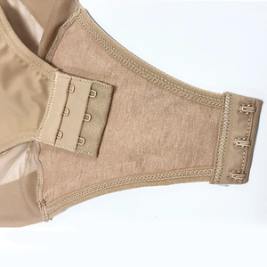 Detail of adjustable hook-and-eye closures and breathable mesh fabric on body shaper