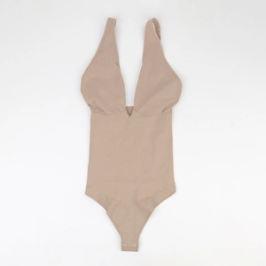 Detail view of high-quality shapewear bodysuit featuring deep V-neck and snap crotch