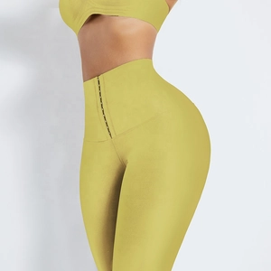 Détail du legging de yoga taille haute avec agrafes gainantes et tissu jaune vif