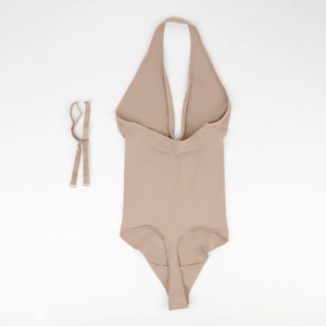 Flat lay of nude halter bodysuit with deep V-neck and adjustable matching straps