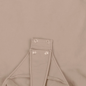 Detail shot of sturdy silver metal snap fasteners on high-elastic knitted bodysuit