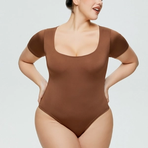 Detail of a brown short sleeve bodysuit featuring a scoop neck and slimming stretchy fabric