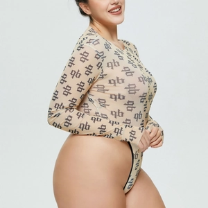 Detail of sheer nude mesh bodysuit featuring all-over monogram print and long sleeves