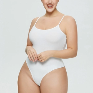 Close-up of white ribbed knit bodysuit fabric with slim shoulder straps and high cut fit
