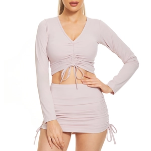 Detail of drawstring and ruched texture on the lilac long sleeve V-neck crop top and skirt