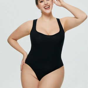 Close-up of black ribbed plus size bodysuit with deep U-neckline and high-cut leg