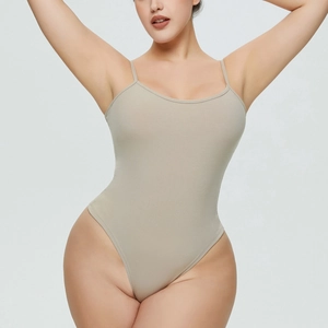 Detailed close-up of ribbed texture and high-cut leg opening on the beige bodysuit