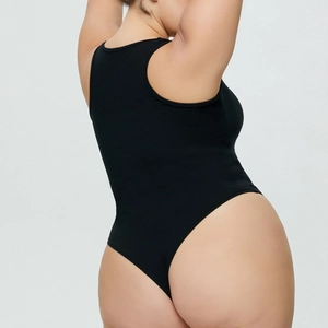 Close-up of black ribbed knit bodysuit featuring high-cut thong design and racerback detail