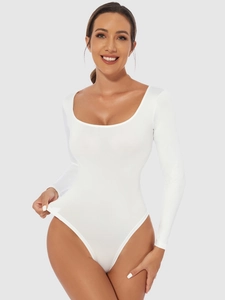 Close-up of white long-sleeve bodysuit featuring a deep scoop neckline and fitted cut