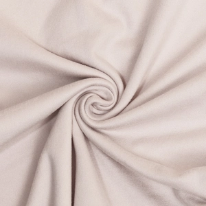 Detailed macro shot of soft pink ribbed knit fabric with elegant spiral texture folds