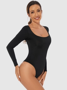 Detail of a slim fit black long sleeve bodysuit with a deep U-neckline on a model