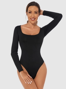 Detail of black long sleeve bodysuit showing square neckline and slim fit design