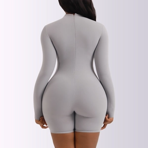 Close-up of the back zipper closure on a grey long sleeve bodysuit in matte stretch fabric