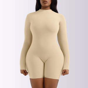 Close-up of the mock neck and high-elastic knit fabric on the apricot long sleeve bodysuit