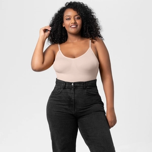 Close-up of seamless beige bodysuit with slim straps paired with high waist black jeans